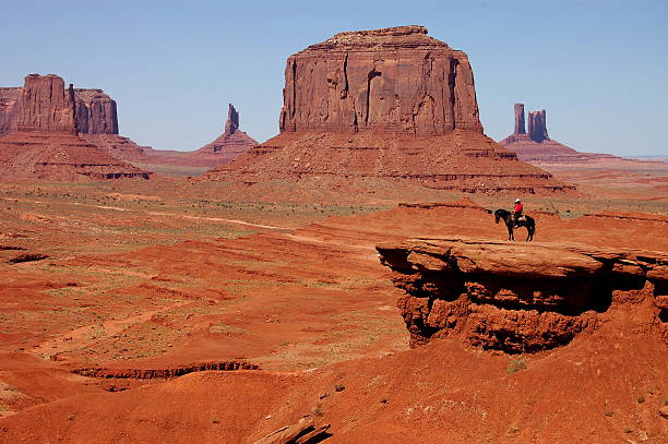 istock Man sits on a horse at Monument Valley in Utah 146999532