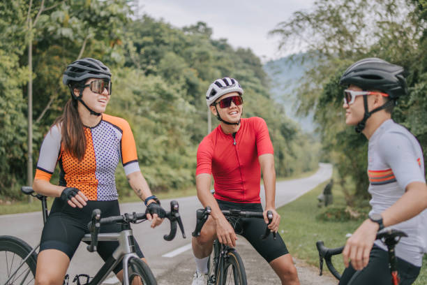 istock Asian Chinese Cyclist resting at roadside waiting for team mates 1469995361
