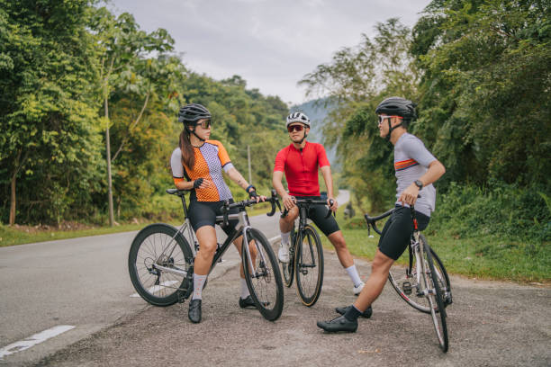 istock Asian Chinese Cyclist resting at roadside waiting for team mates 1469995371