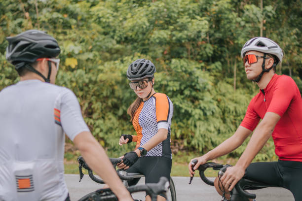 istock Asian Chinese Cyclist resting at roadside waiting for team mates 1469995390