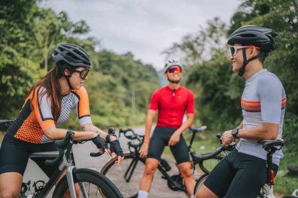 istock Asian Chinese Cyclist resting at roadside waiting for team mates 1469995415