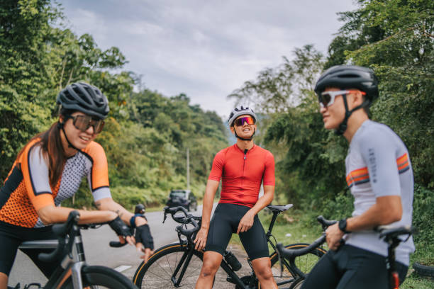 istock Asian Chinese Cyclist resting at roadside waiting for team mates 1469995422