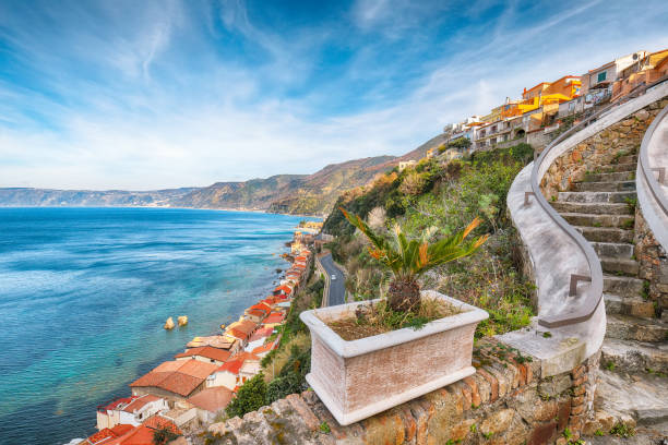 Awesome seaside and town Scilla with old medieval castle on rock Castello Ruffo Awesome seaside and town Scilla with old medieval castle on rock Castello Ruffo, colorful traditional typical italian houses on Mediterranean Tyrrhenian sea coast shore, Calabria, Southern Italy castle scilla stock pictures, royalty-free photos & images