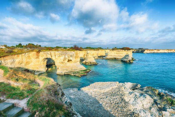 istock Stunning seascape with cliffs rocky arch and stacks (faraglioni) at Torre Sant Andrea 1469995612