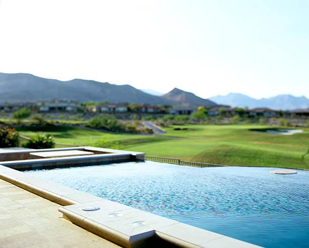 Beautiful view of a garden, with a pool and some mountains in the background