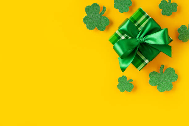 istock Saint Patrick day concept flat lay with green gift box close up on yellow background, 1469995634