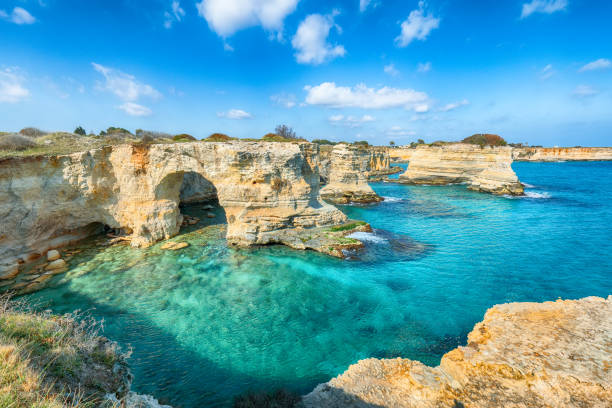 istock Stunning seascape with cliffs rocky arch and stacks (faraglioni) at Torre Sant Andrea 1469995678