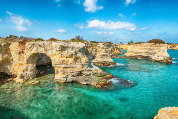 istock Stunning seascape with cliffs rocky arch and stacks (faraglioni) at Torre Sant Andrea 1469995718