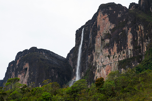 Scenic view of waterfall falling from cliff of Mount Roraima against sky, Roraima, Bolivar State, Venezuela.