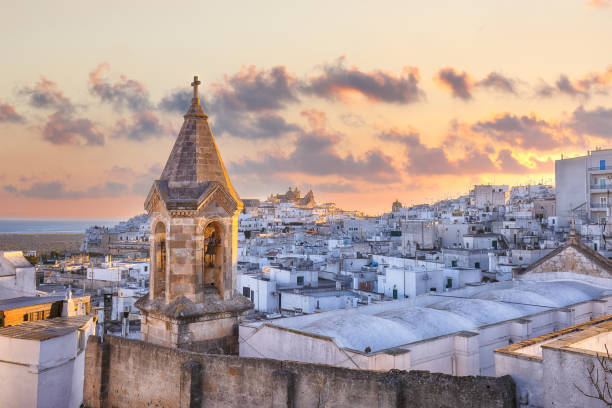 amazing view of old white town ostuni and cathedral at sunrise. - salento imagens e fotografias de stock