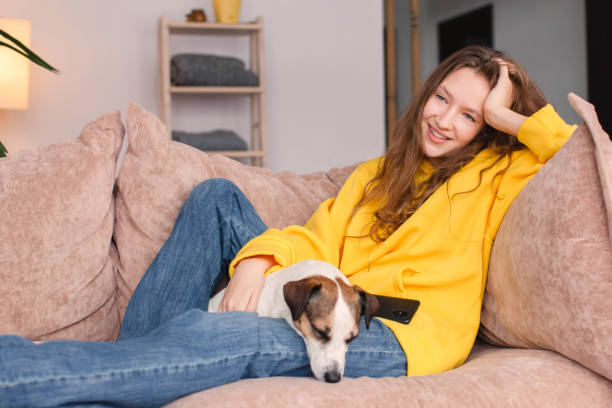 istock Young woman with dog at home 1469996367
