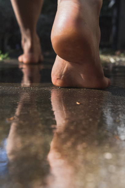 a pair of feet stepped on the wet ground.