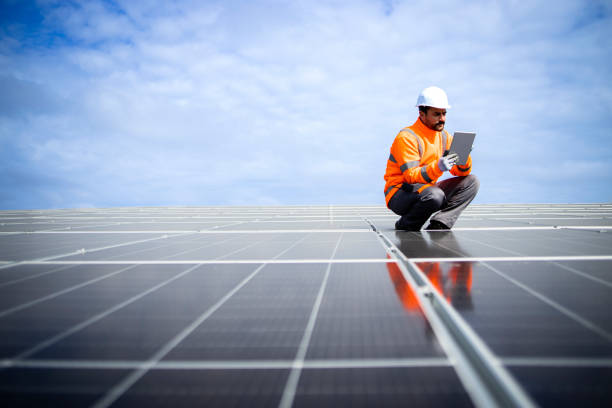 istock Installation of solar panels and professional worker checking quality. 1469997422