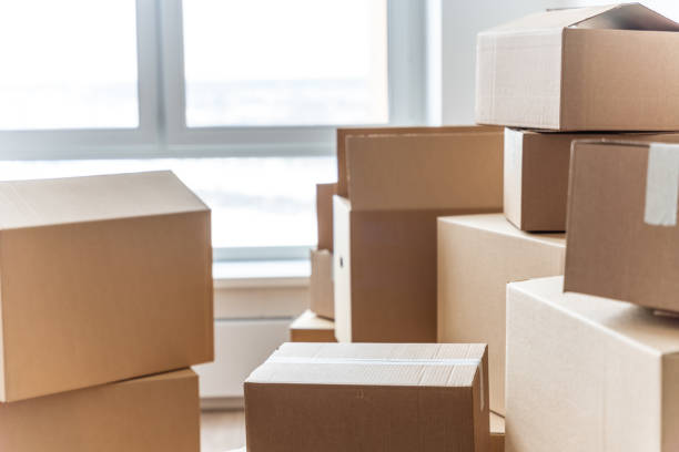 istock Stack of cardboard boxes at empty residential apartment. Moving home concept 1469998880