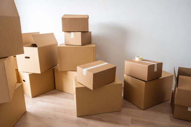 istock Stack of cardboard boxes at empty residential apartment. Moving home concept 1469998935
