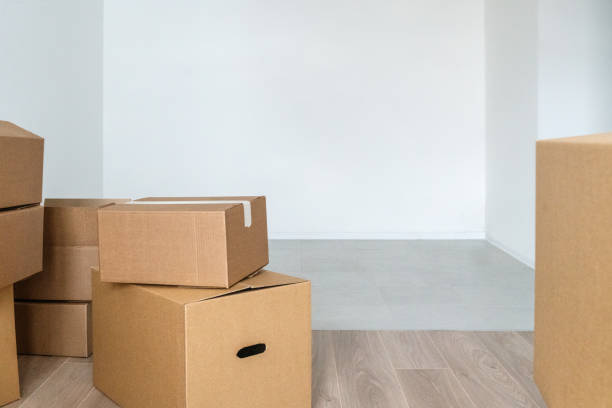 istock Stack of cardboard boxes at empty residential apartment. Moving home concept 1469999020