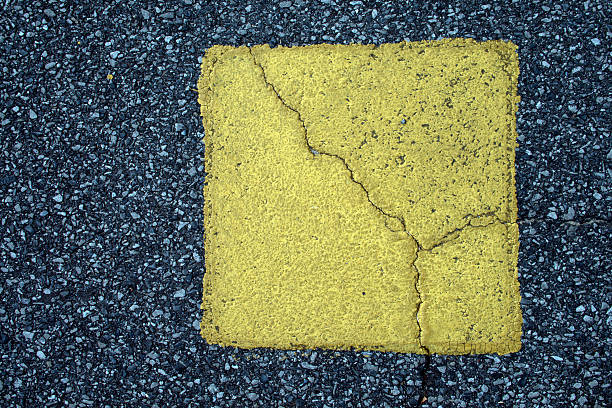 Cracked Pavement with Yellow Square stock photo