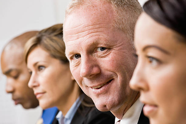 istock Confident businessman sitting with co-workers 147000044