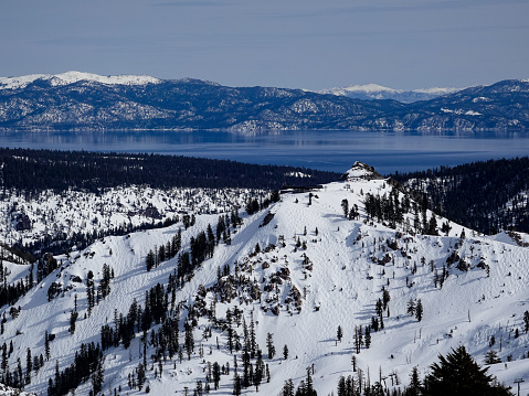 Distant winter view of Lake Tahoe from the top of Palisades Tahoe ski resort, California.