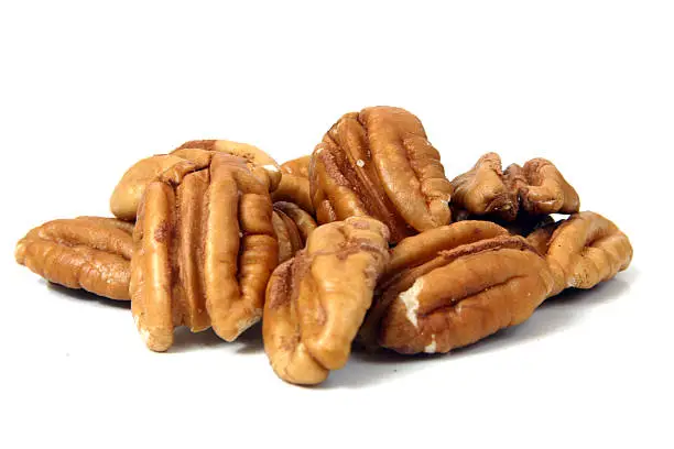 Pile of pecans against a white background.