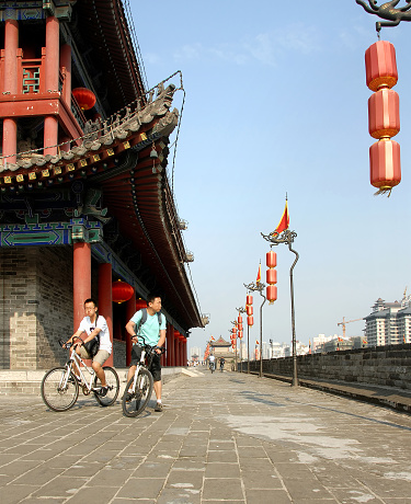 City Wall, Xian, Shaanxi Province, China. The City Wall of Xian is one of the best preserved in China. People cycling on the top of Xian city wall.