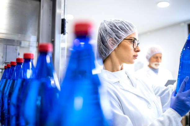 istock Bottling factory workers checking product quality and productivity. 1470002025