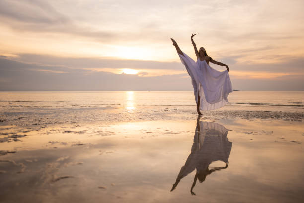 istock Woman in white dress dancing 1470002084