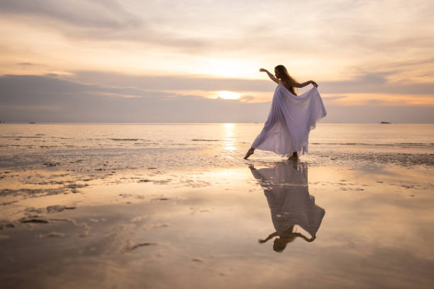 istock Woman in white dress dancing 1470002745