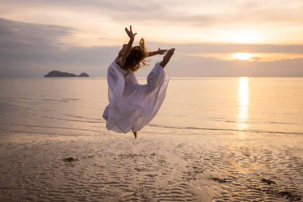 istock Woman dancing in sunset 1470002809