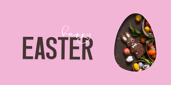 Happy Easter text and cut out Easter egg and chocolate bunny and eggs.  Happy Easter greeting card.