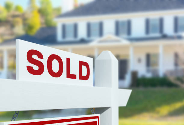 Sold For Sale Real Estate Sign in Front of New House. stock photo