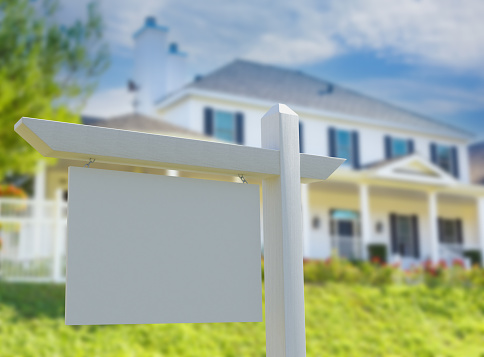 Blank Real Estate Sign in Front of New House.