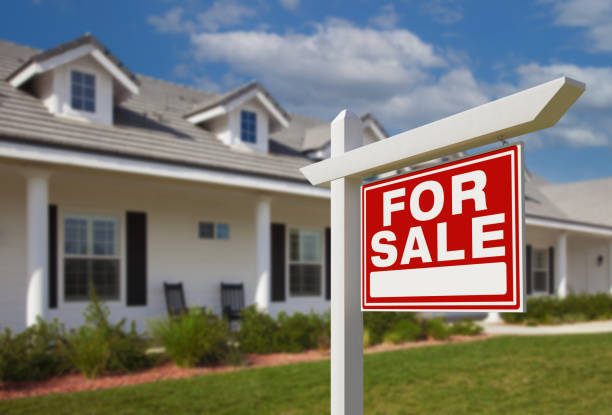 For Sale Real Estate Sign in Front of New House. stock photo
