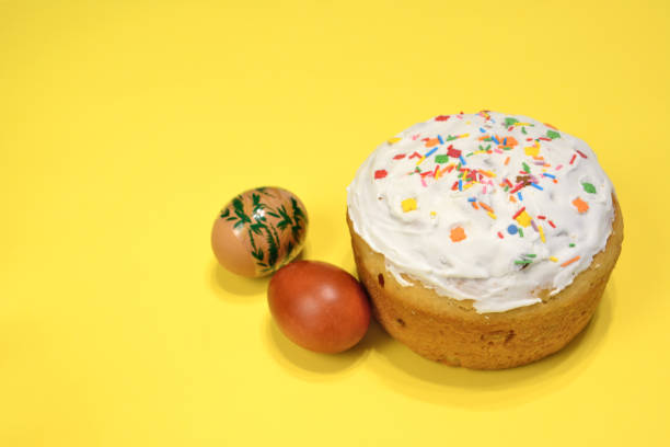 istock A cake with sprinkles and brown eggs on a yellow background, close-up 1470008206