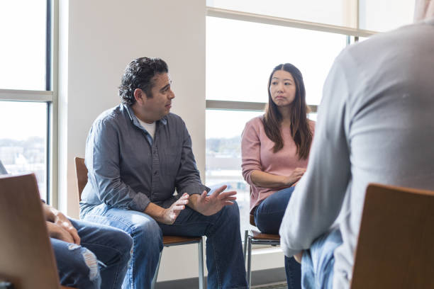 istock Mature man gestures and shares sad news with support group 1470008221