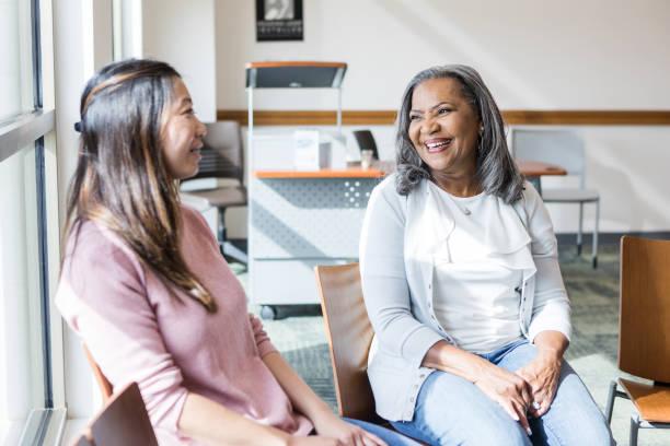istock Diverse friends smile and chat before support group meeting 1470008223