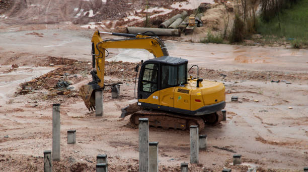 istock An excavator is working to insert stake or concrete foundation pillars into the ground on a construction site project. 1470008240