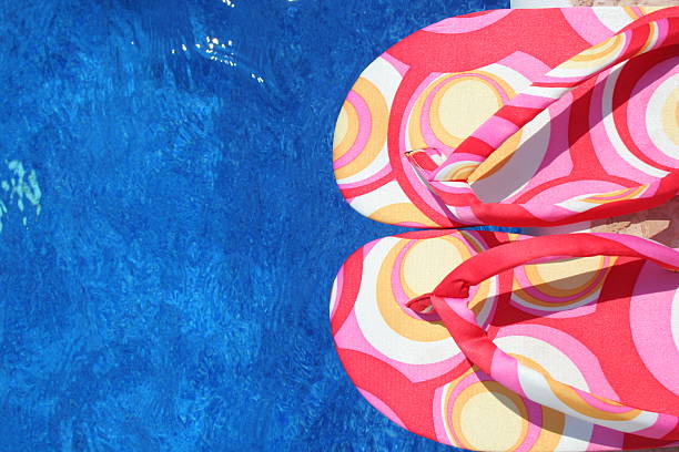 istock colorful summer sandals over blue water 147000830