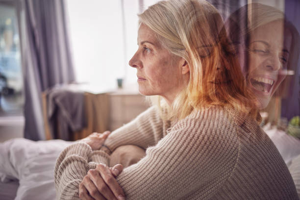 istock Depression, psychology and bipolar woman on sofa with split personality issue, problem and medical condition. Mental health, anxiety and exposure of faces of senior female with moods, fear and crisis 1470008344