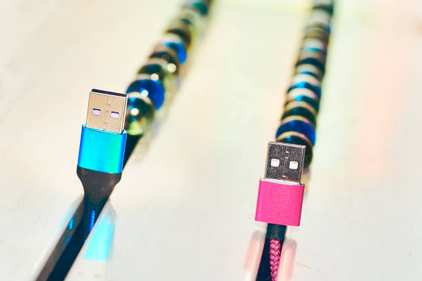 blue and pink usb cords with abstract colorful balloons decor - connection merger road togetherness imagens e fotografias de stock