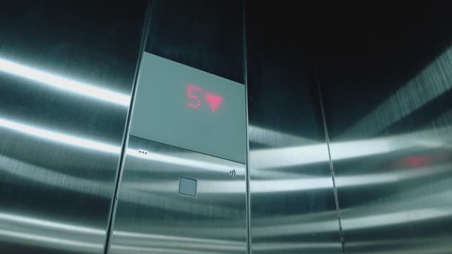 Cabin of modern passenger elevator. Digital lift scoreboard showing floor number. Digital display in the elevator which rises up on floor with an arrow up. Lift go up to the seventh floor. 7st to 1st