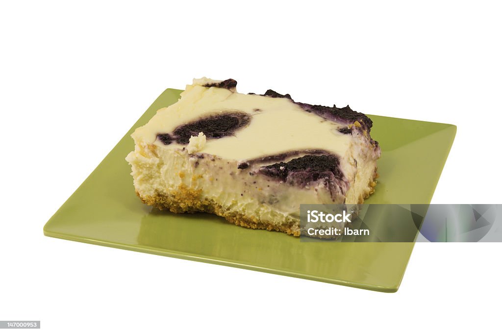 blueberry swiirl cheesecake on white simple swirl blueberry cheesecake on green plate on white Blue Stock Photo