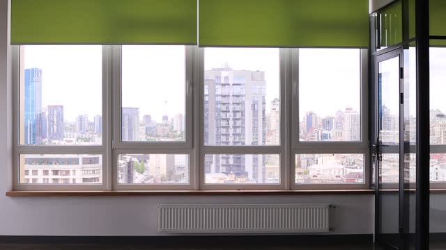 Video of roller blinds close-up on the window in the interior.