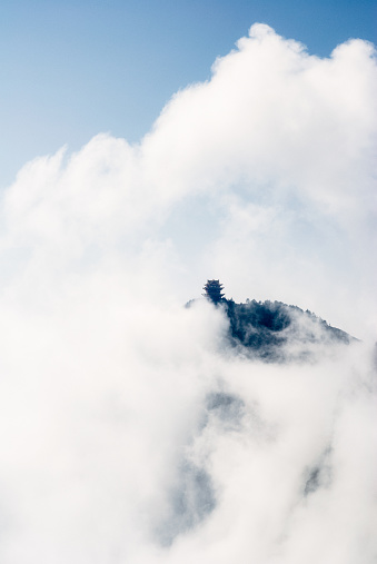 Shrouded in mist and cloud, one of the temples silhouetted on a mountain ridge at Emei Shan in China's Sichuan Province.