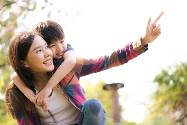 istock Mother and son playing together at the park. 1470010557