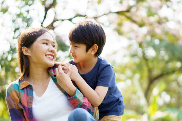 istock Mother and son playing together at the park. 1470011395