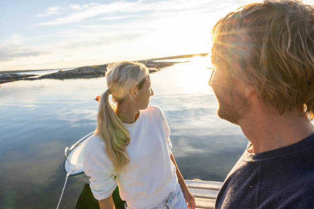istock Couple relaxing on pier above lake at sunset 1470011414