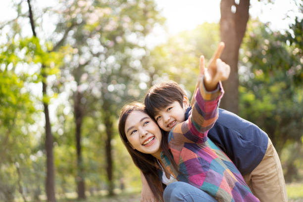 istock Mother and son playing together at the park. 1470011421