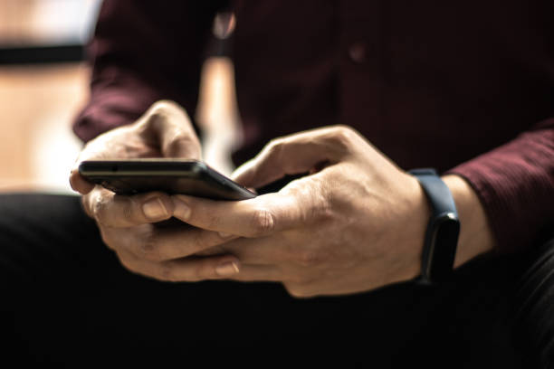 istock Close-up of a man using mobile phone 1470011636