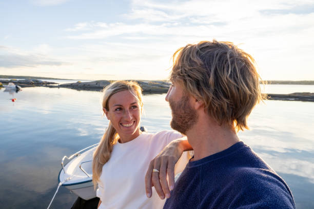 istock Couple relaxing on pier above lake at sunset 1470011646